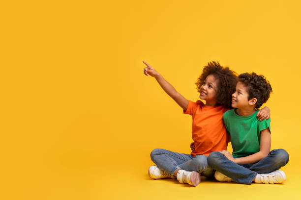 istock Siblings sitting and looking at a distance 2157723286