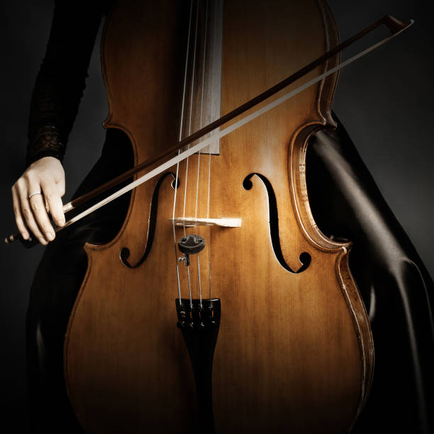 istock Cello player. Musician cellist hand with bow playing musical instrument close up 2157724980