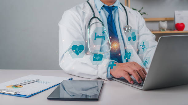istock A doctor using computer to review treatment plan and write document reports in hospital office, Healthcare worker and doctor service, Digital laptop in modern office, Medical technology concept. 2157728299