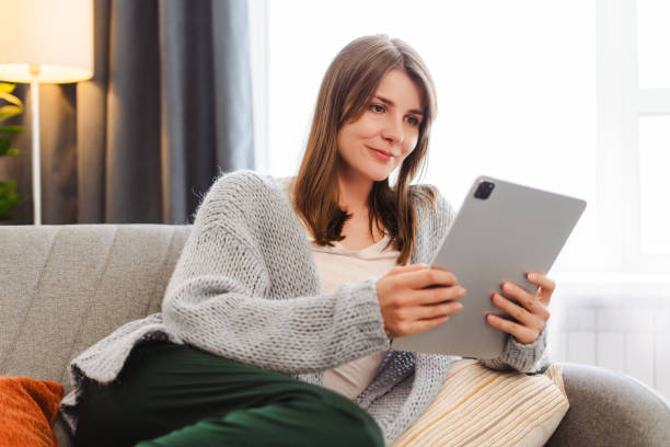 istock Beautiful woman, female manager, freelancer holding digital tablet, using, ordering, checking mail 2157728535