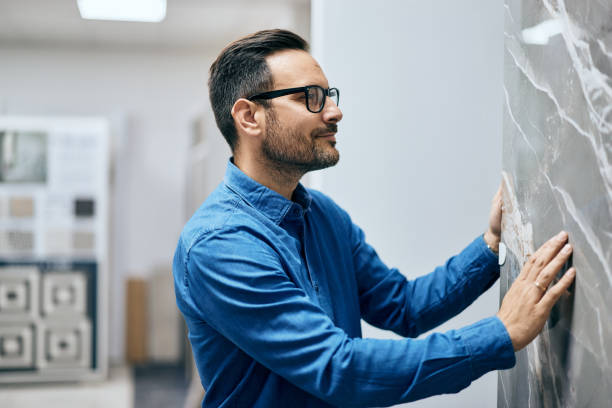 istock The side profile of a male searching a design for a kitchen worktop. 2157728661