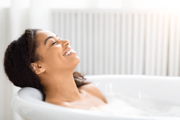 istock Woman relaxing in a bubble bath and smiling 2157729760