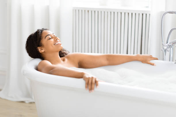 istock Happy woman lying in bubble bath at home 2157729762