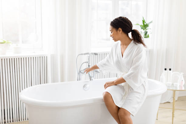 istock Smiling woman about to take a bath 2157729813
