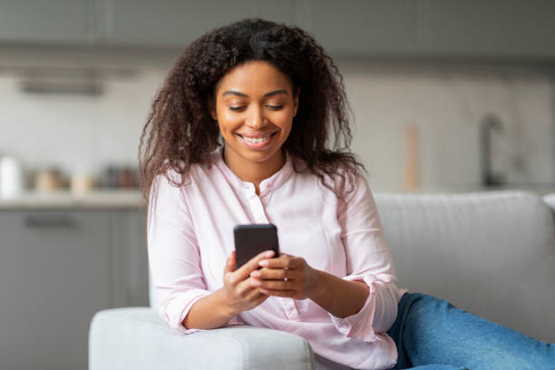 istock Relaxed lady texting on smartphone at home 2157730004