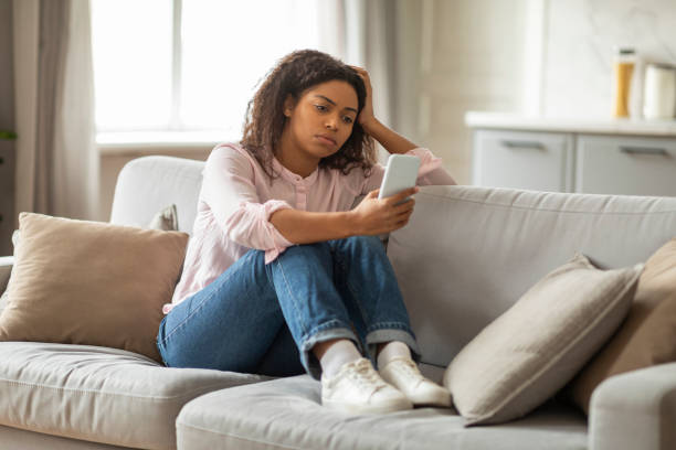 istock African American Lady Overwhelmed by Digital Communication at Home 2157730105