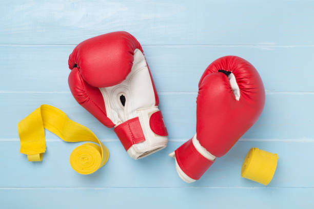 istock Red boxing gloves on wooden background, top view. 2157730656
