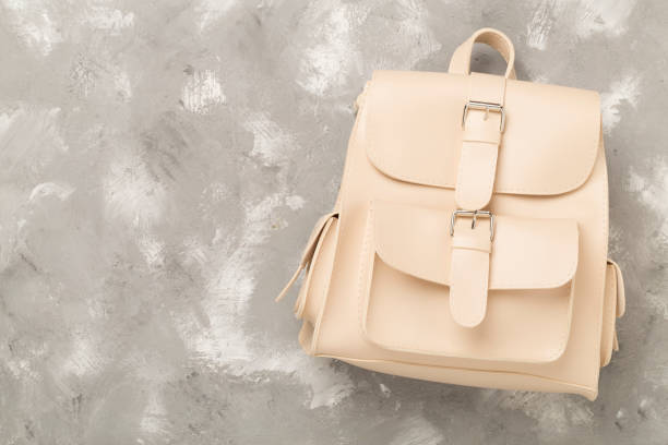 istock Beige stylish backpack on concrete background, top view. 2157730728