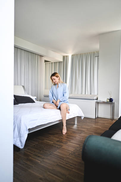 istock Barefoot woman relaxing in bedroom. 2157736251