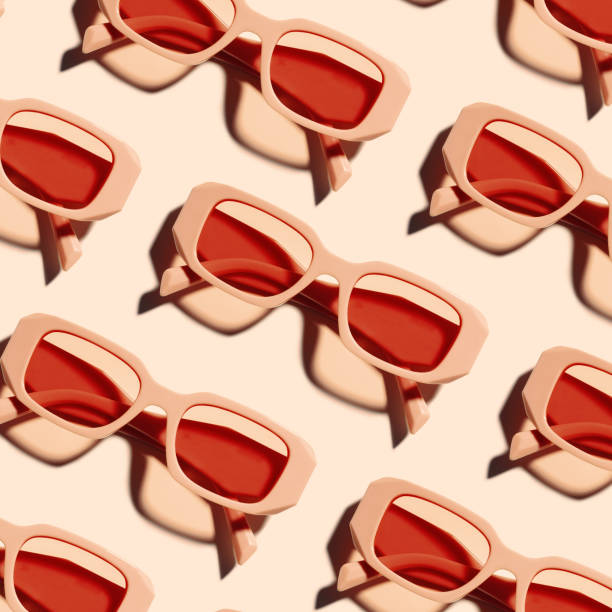 istock Pattern of pink color sunglasses on pastel pink background at sunlight with shadow. Summer fashion eyeglasses with rose colored glass. Summer vacation, rest concept. Minimal style flat lay, top view 2157737041