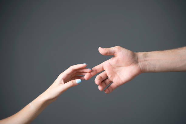 istock A close-up view captures the tender touch between a mans and a womans hand against a neutral gray backdrop. 2157740198