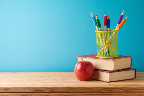 istock Back to school concept with books, pencils and apple over blue background 2157740669