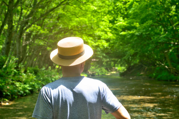 Senior man enjoying the coolness of a mountain stream