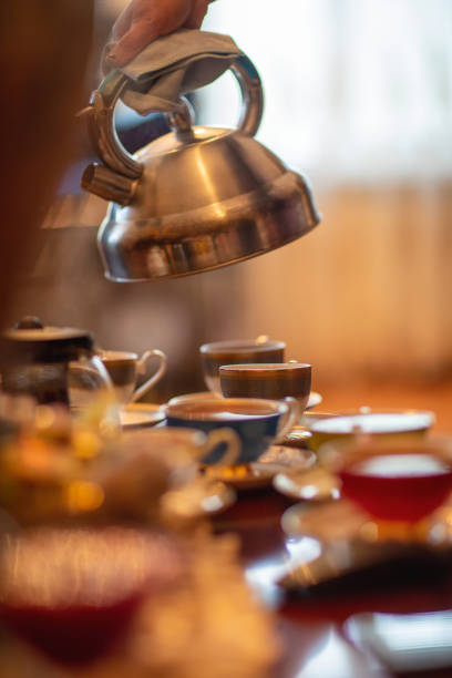 istock Hot water pouring into iron teapot for making a tea 2157741384