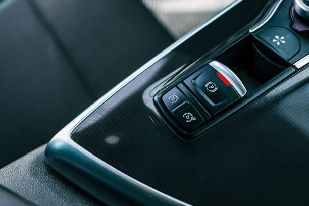 Electronic handbrake button. Gear shift stick into P position, (parking) symbol in automatic transmission car. Modern automatic gearbox car. Car detailing. Interior car inside. handle closeup.