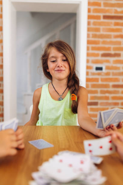 istock Children having fun playing card game on the kitchen table 2157743210