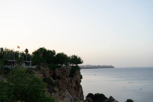Cliff, tree, sea and Turkish Flag - Sunrising at Antalya, Turkey (Türkiye)
