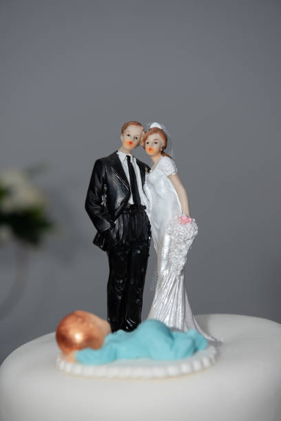 istock Bride and groom couple doll on wedding cake.miniature 2157749375