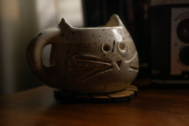 Woman using clay to make handmade mug at pottery studio