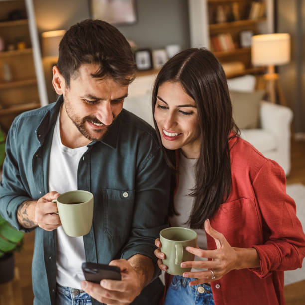 istock Couple use mobile phone for text message or browse internet at home 2157749963