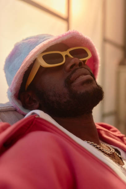 istock Closeup Black Man Wearing Sunglasses Relaxing in Dark 2157752105