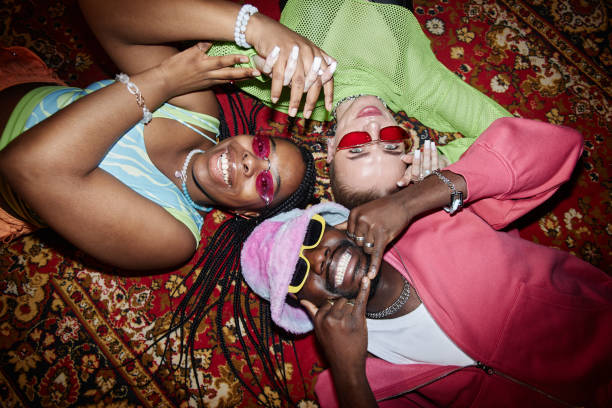 istock Top View Three Trendy Young People Lying on Carpet 2157752129