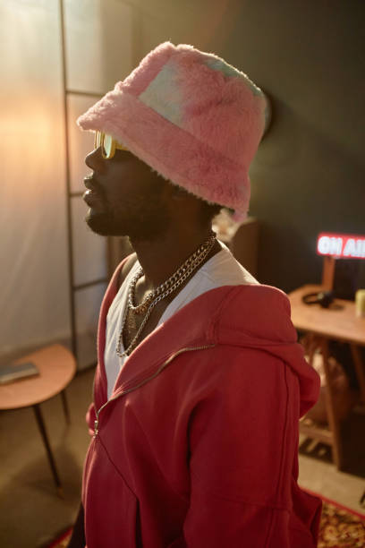 istock Black Man Wearing Pink Bucket Hat with Dim Light 2157752141