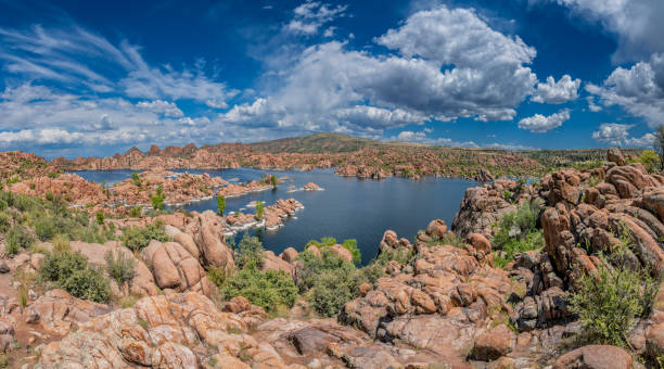 The Granite Dells are a geological feature characterized by exposed granite rock formations that have been sculpted by wind and water over millions of years into unusual shapes and patterns.  The term “dells” refers to the valleys or low areas between the granite formations.  Nestled among these natural wonders lies Watson Lake, a reservoir formed in 1915 when early settlers dammed Granite Creek. This juxtaposition of geological history and human intervention creates a serene oasis, inviting visitors to ponder the passage of time and marvel at the forces of nature.  Watson Lake and the Granite Dells are in Prescott, Arizona, USA.
