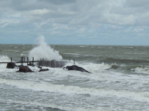 istock bridge over the water in the sea with waves bouncing off the rocks 2157755067