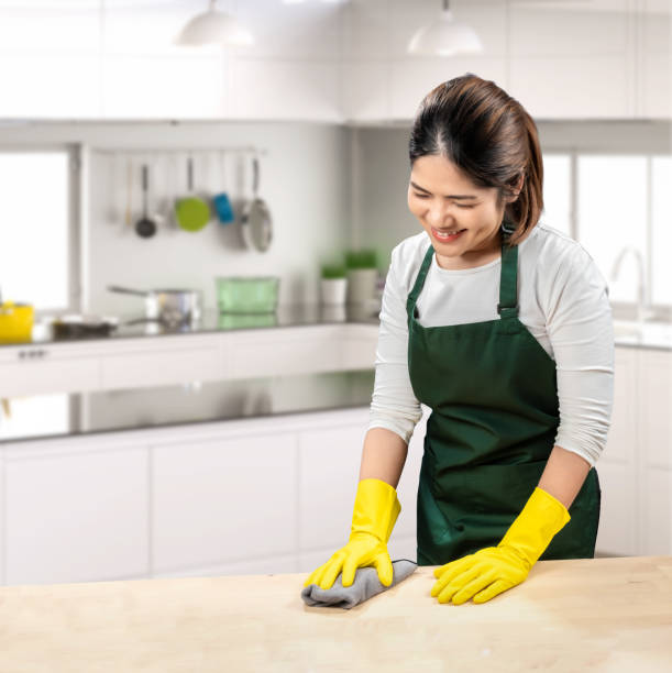 istock Asian housekeeper wear gloves apron 2157757363
