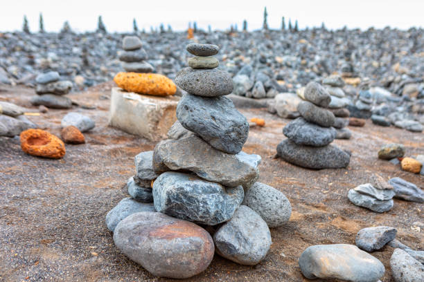 Pile of rocks delicately stacked on top of each other on the beach. Harmonious coastal structure