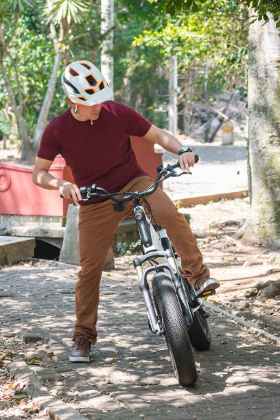 istock Latin man riding an electric bicycle 2157764124