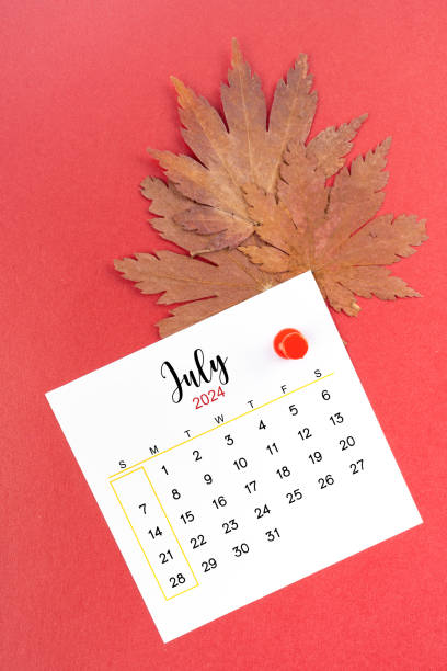 istock July 2024 calendar page and autumn maple leaf with thumbtack 2157764306