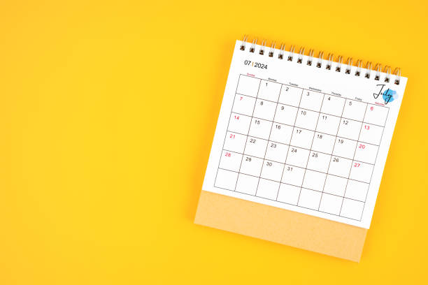 istock July 2024 desk calendar on yellow color background. 2157764323