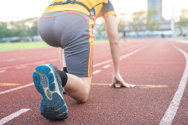 istock Athletic sport running man prepare start sprint run in running field 2157764358
