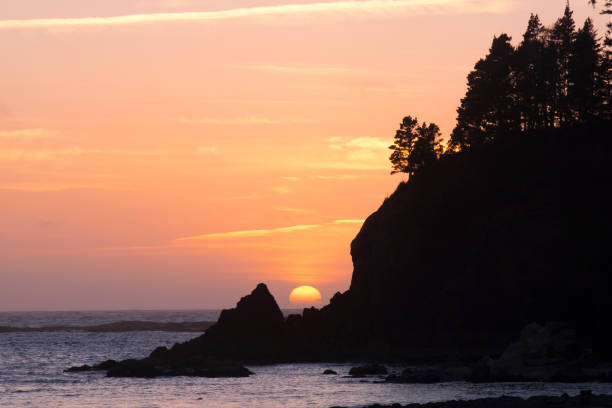 North America, Oregon, Sunset Bay State Park. Sunset behind rocky point.