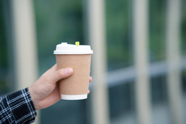 istock A young man's hand holding a coffee cup on university campus 2157766640