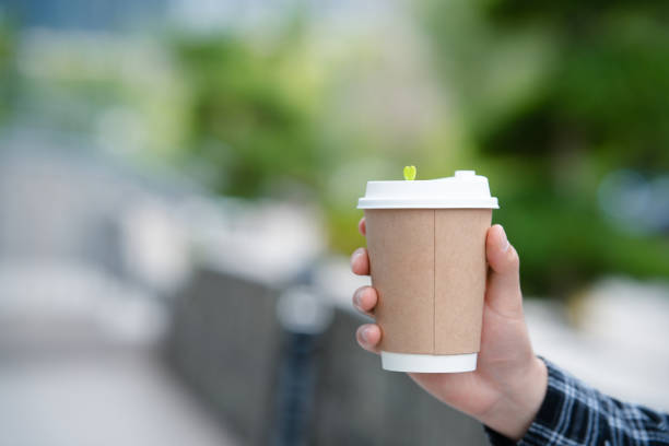 istock A young man's hand holding a coffee cup on university campus 2157766668