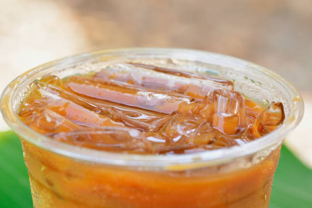 the wide view close-up image of Thai iced coffee on banana green leaf