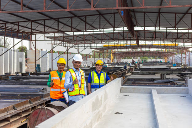 istock Foreman and workers in a construction factory 2157781747