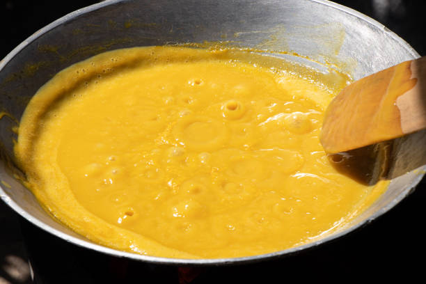 istock Stir-frying mango with wooden spoon in pan, prepared for stirring fruit. Making mango jam for make dried mango paste during mango season. 2157782993