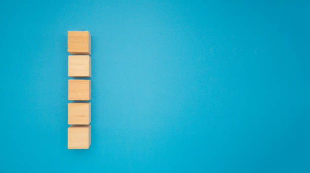 istock Five wooden cubes are on a blue background. 2157783800