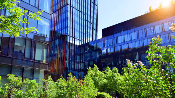 istock Sustainable glass office building with trees for reducing carbon dioxide. 2157783930