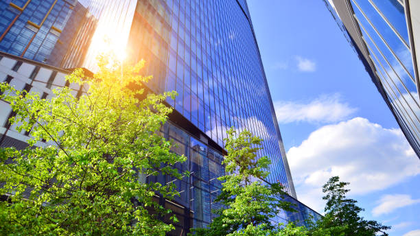 istock Sustainable glass office building with trees for reducing carbon dioxide. 2157783978