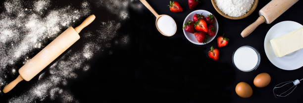 istock Ingredients for making strawberry pie or cake on the black background. Copy space. Top view. 2157784835