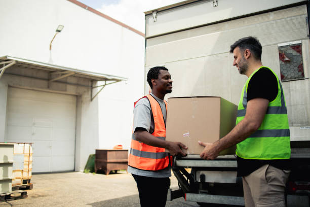 istock Warehouse workers storing boxes into the truck 2157785585