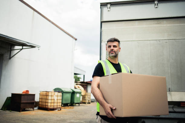 istock Portrait of a warehouse worker carrying the box 2157785587