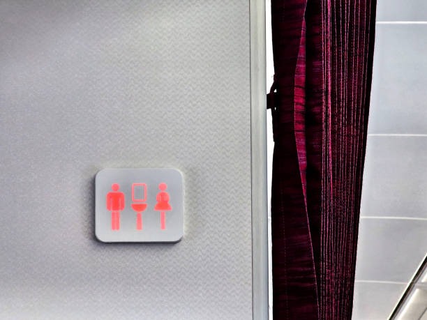 Red sign of lavatory in the airplane . the red light means the bathroom is busy