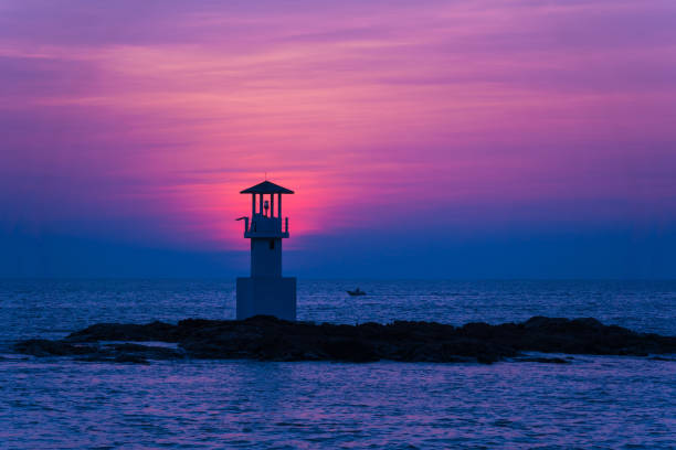 istock A lighthouse in the ocean during a beautiful sunset 2157788472