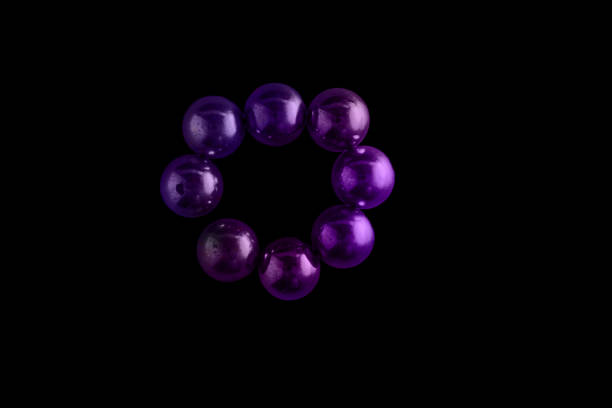 Purple spheres forming a circle on a black background, representing minimalism